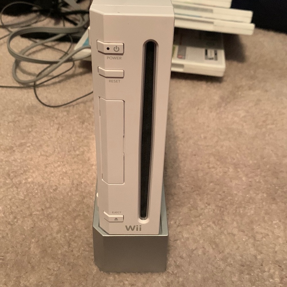 Wii console, 11 games, remotes, and carrier bag